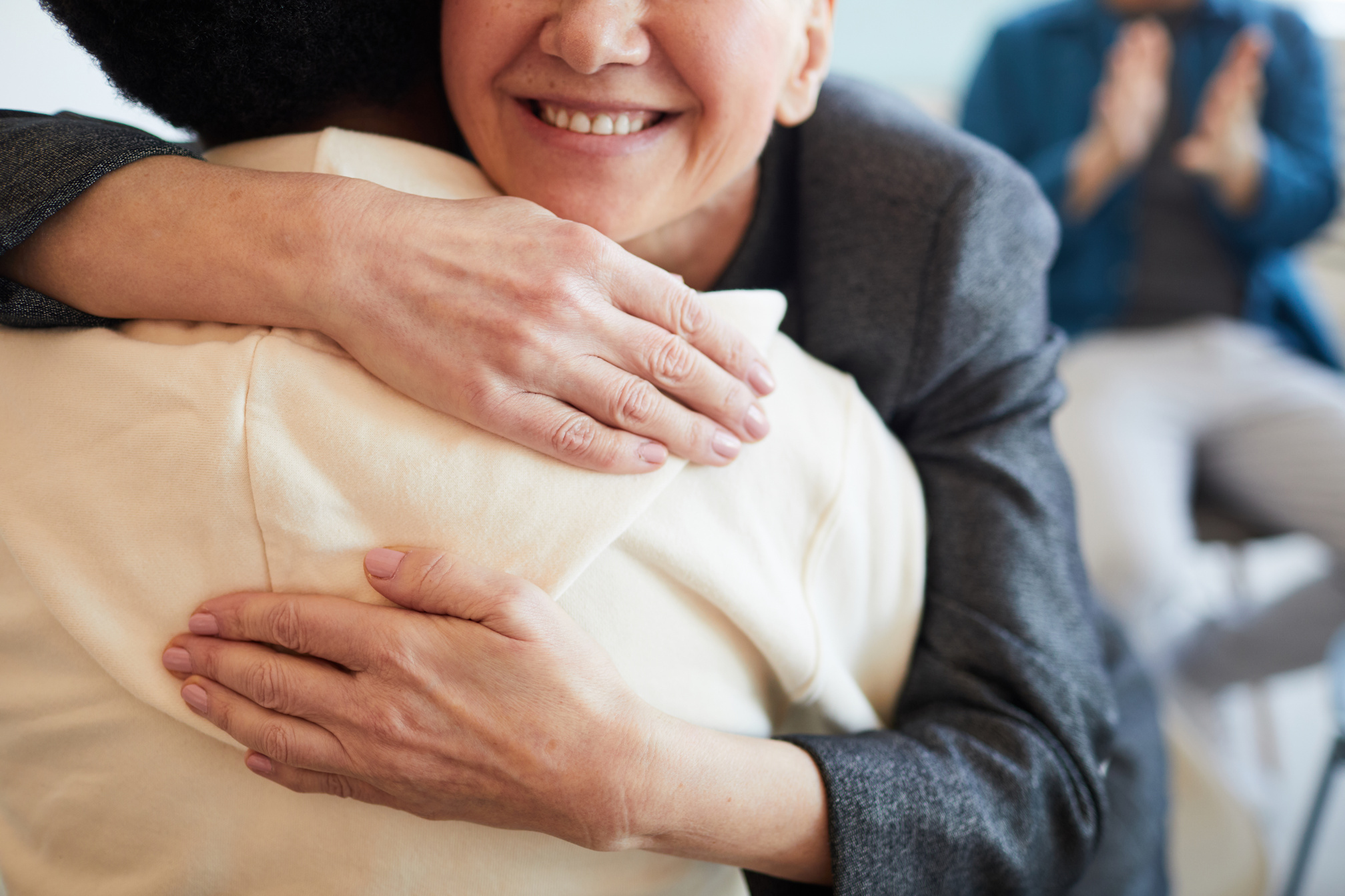 Smiling Psychologist Embracing Patient in Support Group